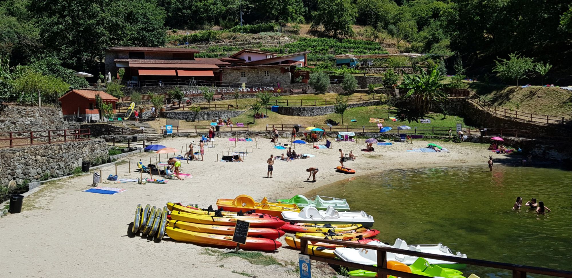 RESEÑA- Playa Fluvial de A Cova ( Ribeira Sacra, Lugo)."Donde el río Miño se ensancha en calma y el verde gallego abraza el horizonte, aparece A Cova, un pequeño paraíso escondido entre viñedos y montañas."Si hay un rincón que me ha robado el corazón este verano, ha sido la Playa fluvial de A Cova, en plena Ribeira Sacra. No es una playa cualquiera: es un lugar tranquilo, con aguas mansas del río Miño, rodeado de naturaleza y viñedos que parecen colgar del cielo. Un auténtico paraíso interior donde desconectar y respirar. Guía de Mototurismo Galicia | SUKI ON THE ROAD
